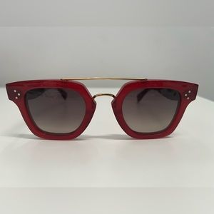 Celine red sunglasses with gold detail.